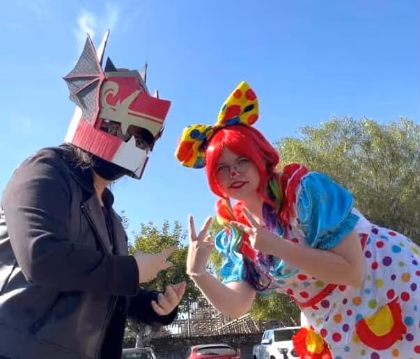 Me with my helmet, posing with someone dressed like a clown.