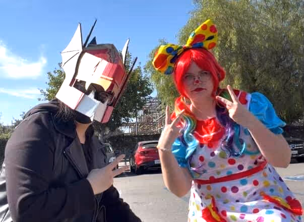 Me with my helmet, posing with someone dressed like a clown.