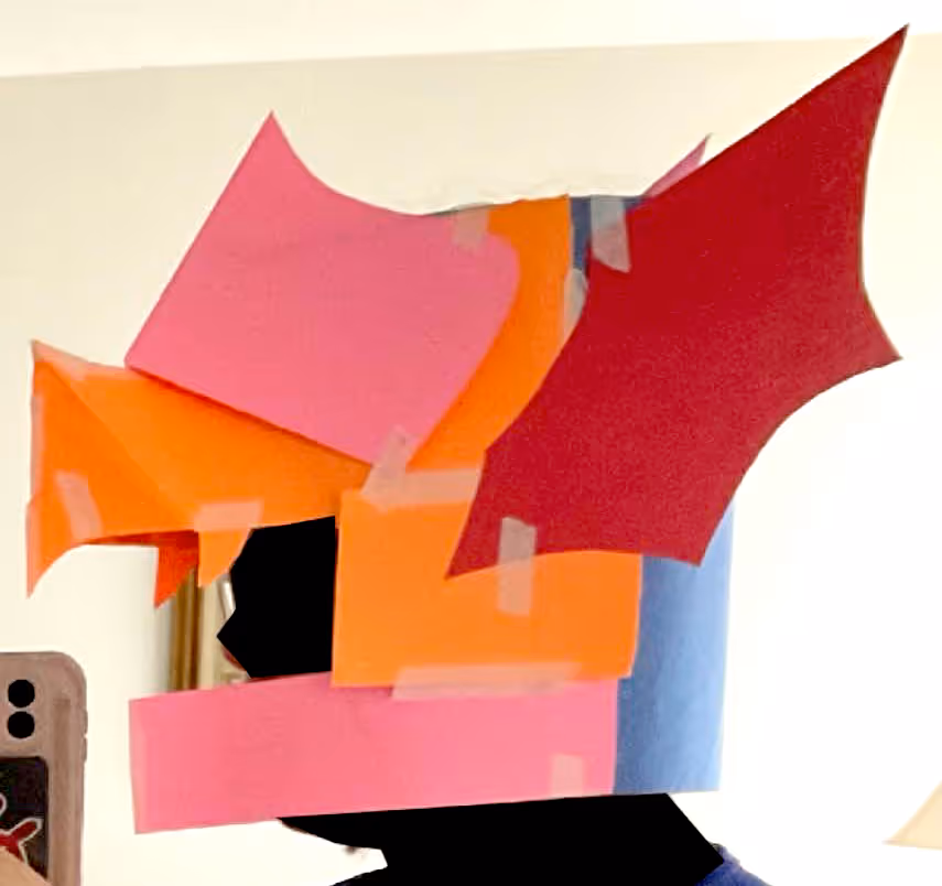 A side profile of a construction paper helmet.