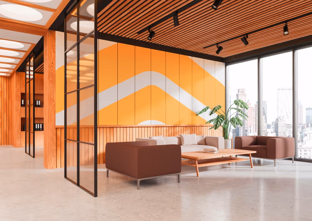 A modern-looking waiting room. The wall has a painted yellow mural of part of Kaiser's logo.