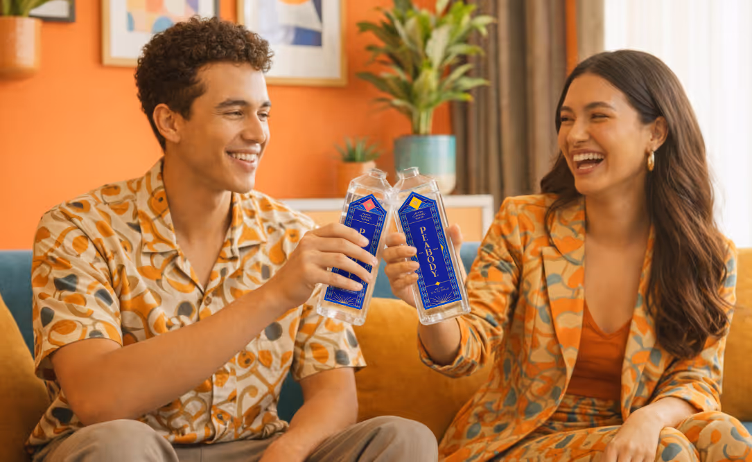An AI-generated photo of two people smiling and clinking their glass bottles of flavored water.