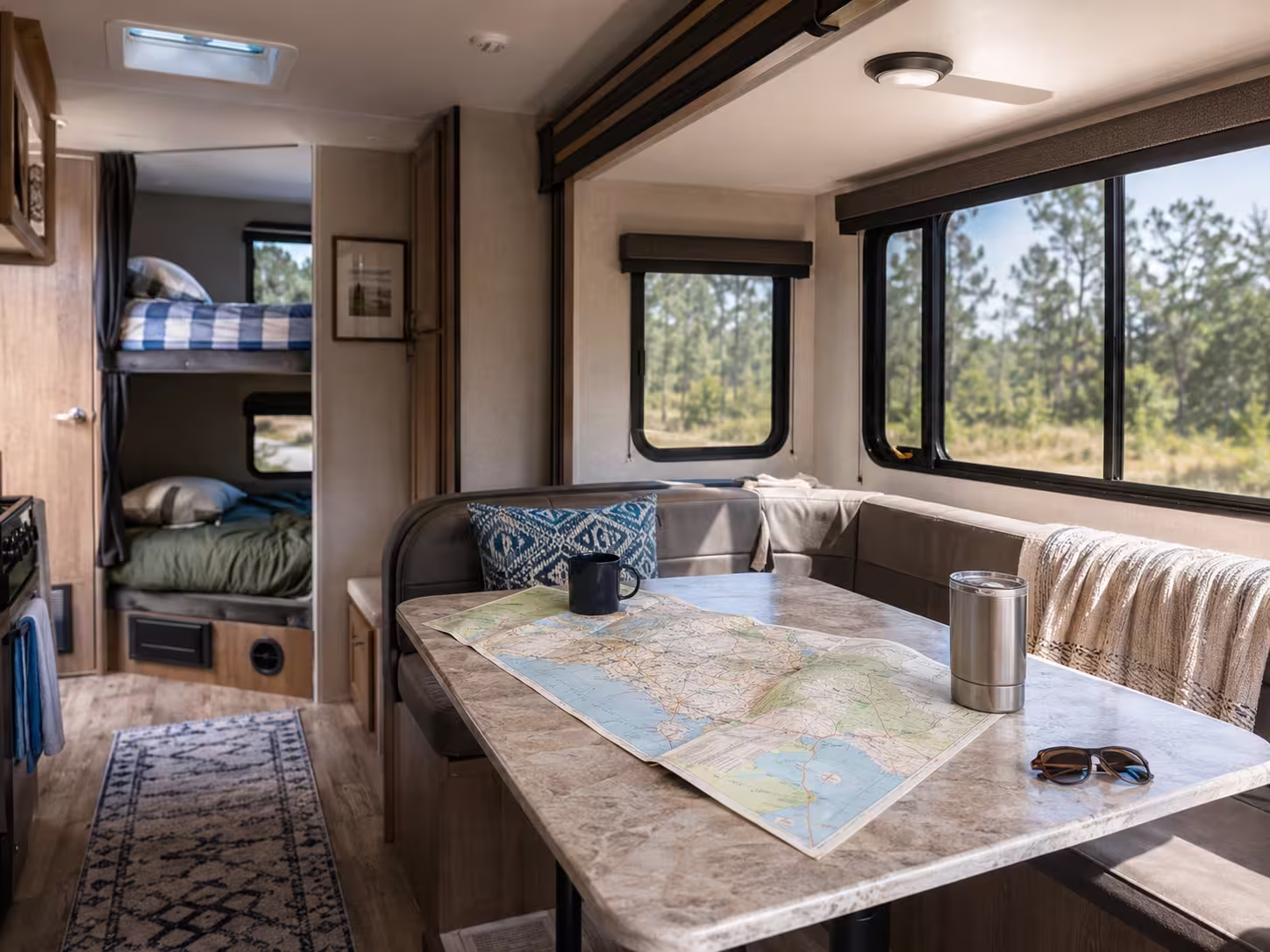 Large RV interior slide-out with bunk beds and dinette