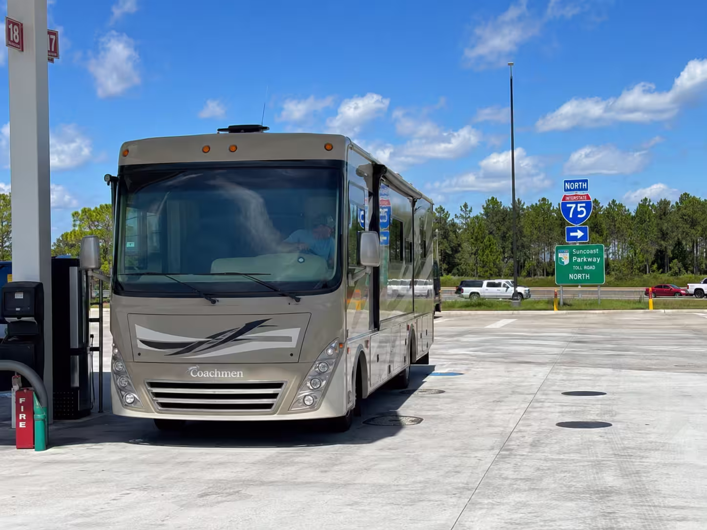Class A motorhome at a Suncoast Parkway fuel stop near Brooksville