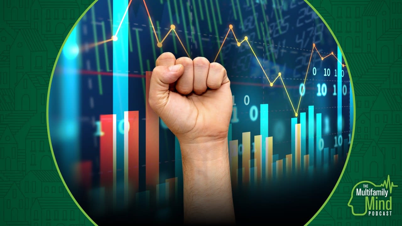 raised fist in front of several graphs