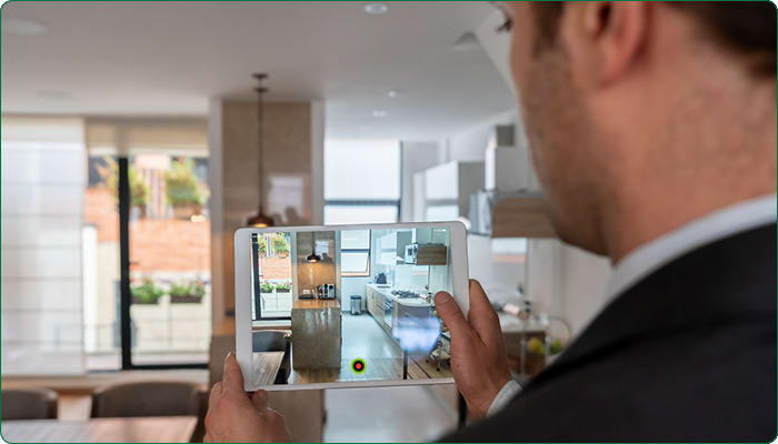 man recording an apartment living room on an ipad