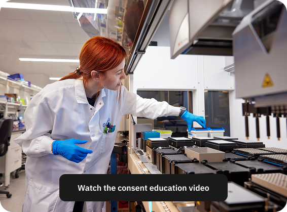 Scientist in a lab coat and gloves working with lab equipment on an automated system.