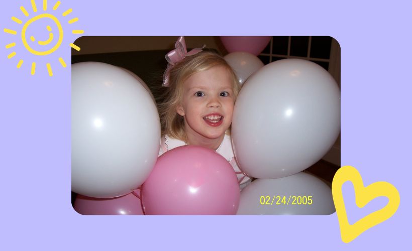 Abbie in a pile of balloons in 2005.