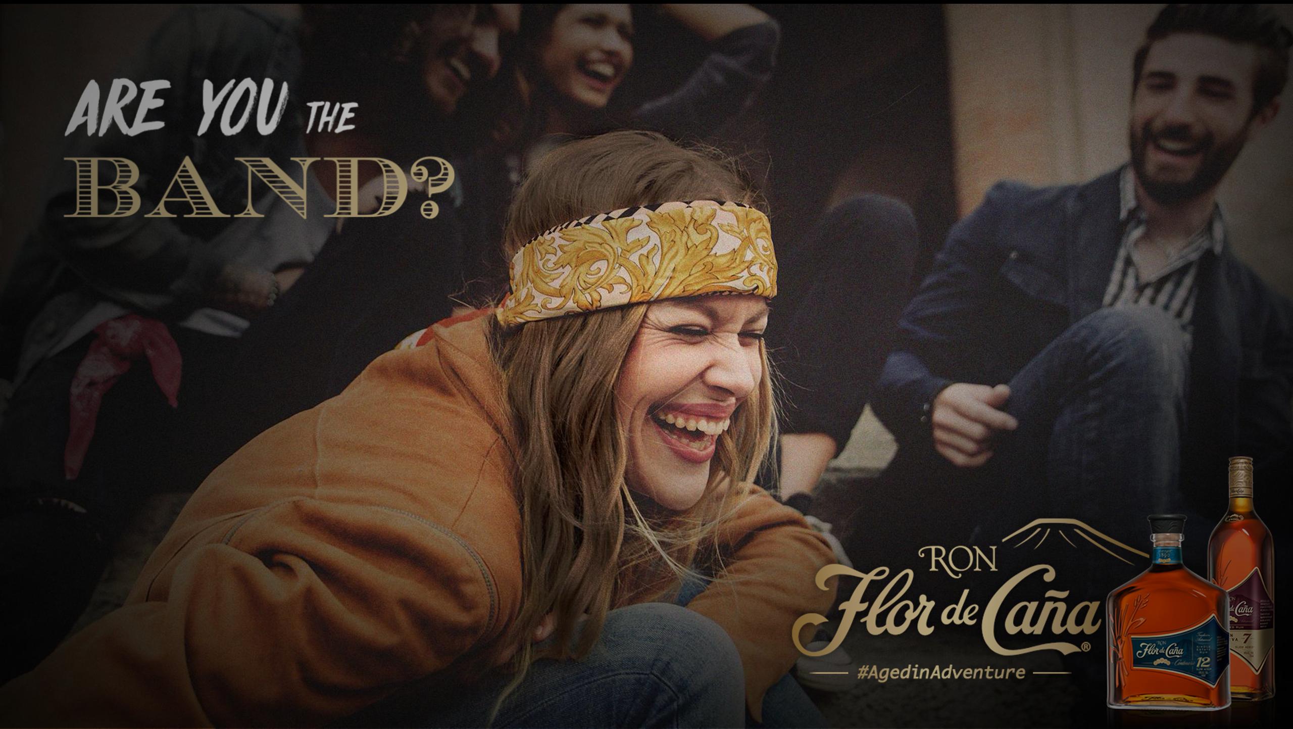 Group of young adults laughing outdoors with 'Are you the band?' text and two bottles of Ron Flor de Caña rum at bottom right.