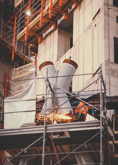 Welder on scaffolding working at client location