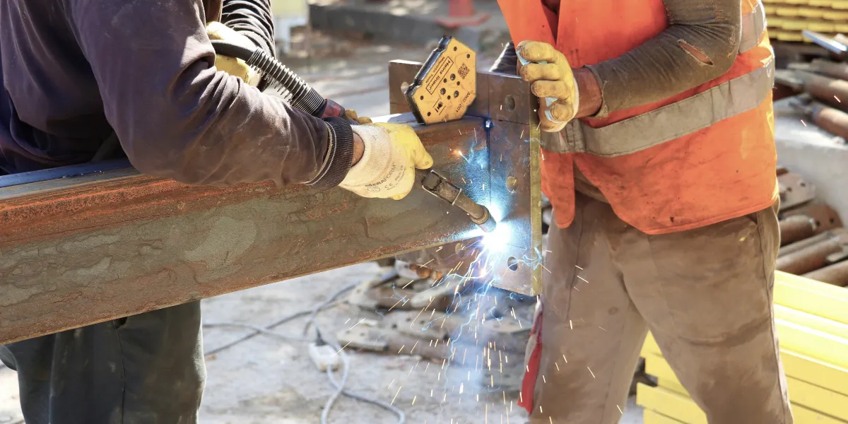 Two welders working together