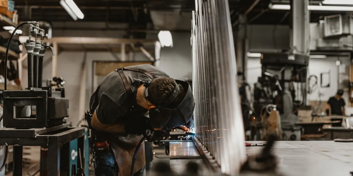 Welder in shop working on project