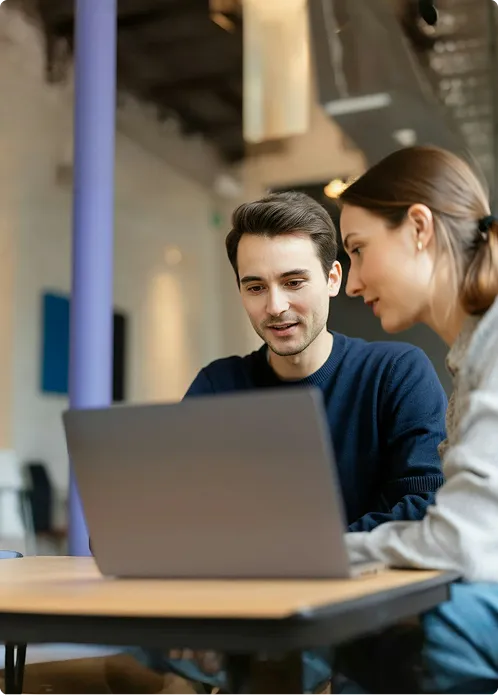 Launchist team members meeting and working together at a desk 