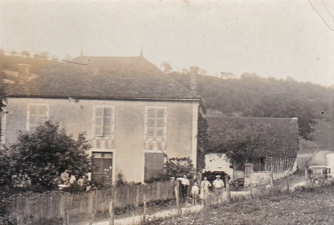 The Rigollot family standing in front of their traditional stone house in the Côte d'Or region of France — symbolizing heritage, terroir, and generational winemaking values.