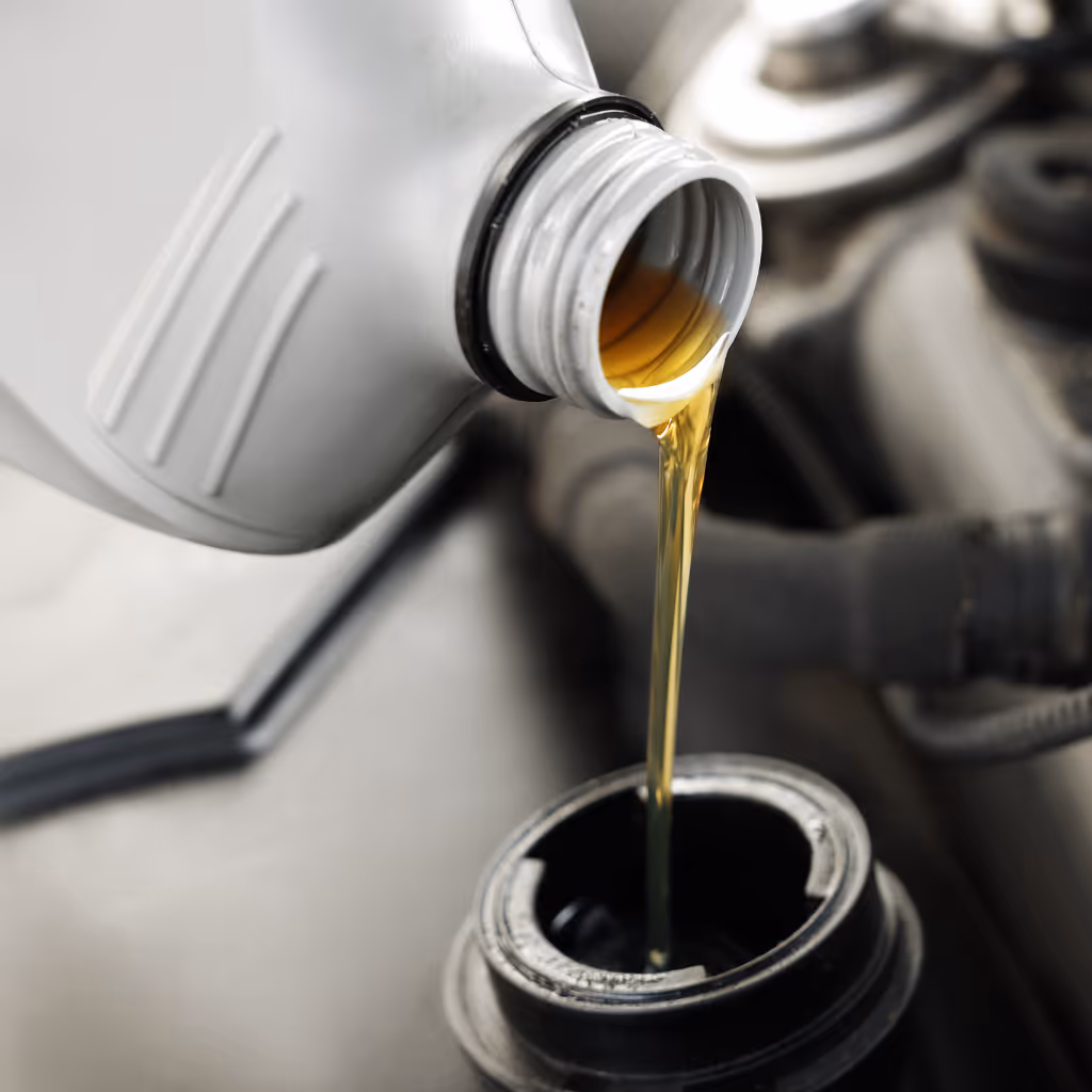 Clean engine oil being added to a customer's vehicle during a convenient mobile oil change service by Maxamy Mobile Autocare.