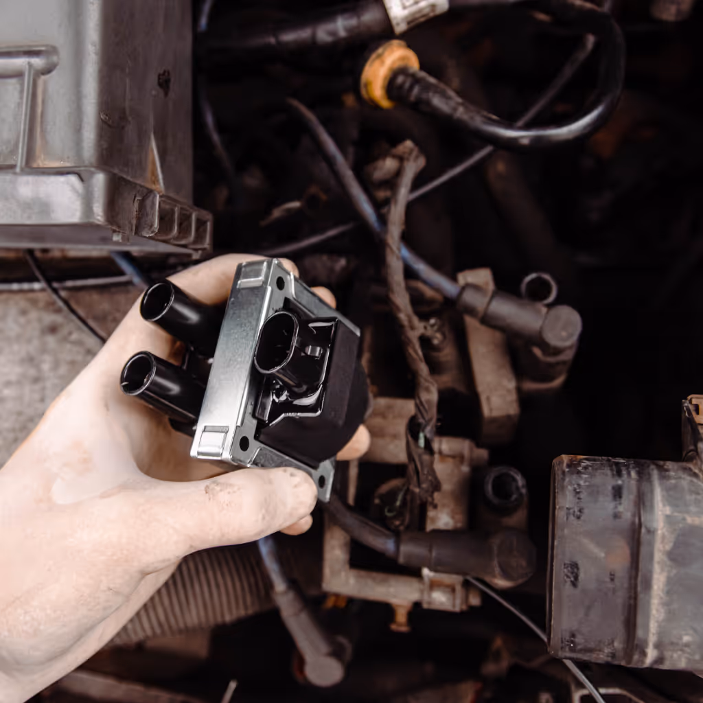 Removing a faulty ignition coil pack. Maxamy Mobile Autocare diagnoses misfires and rough running caused by failed coils, providing convenient on-site replacement to restore engine power.
