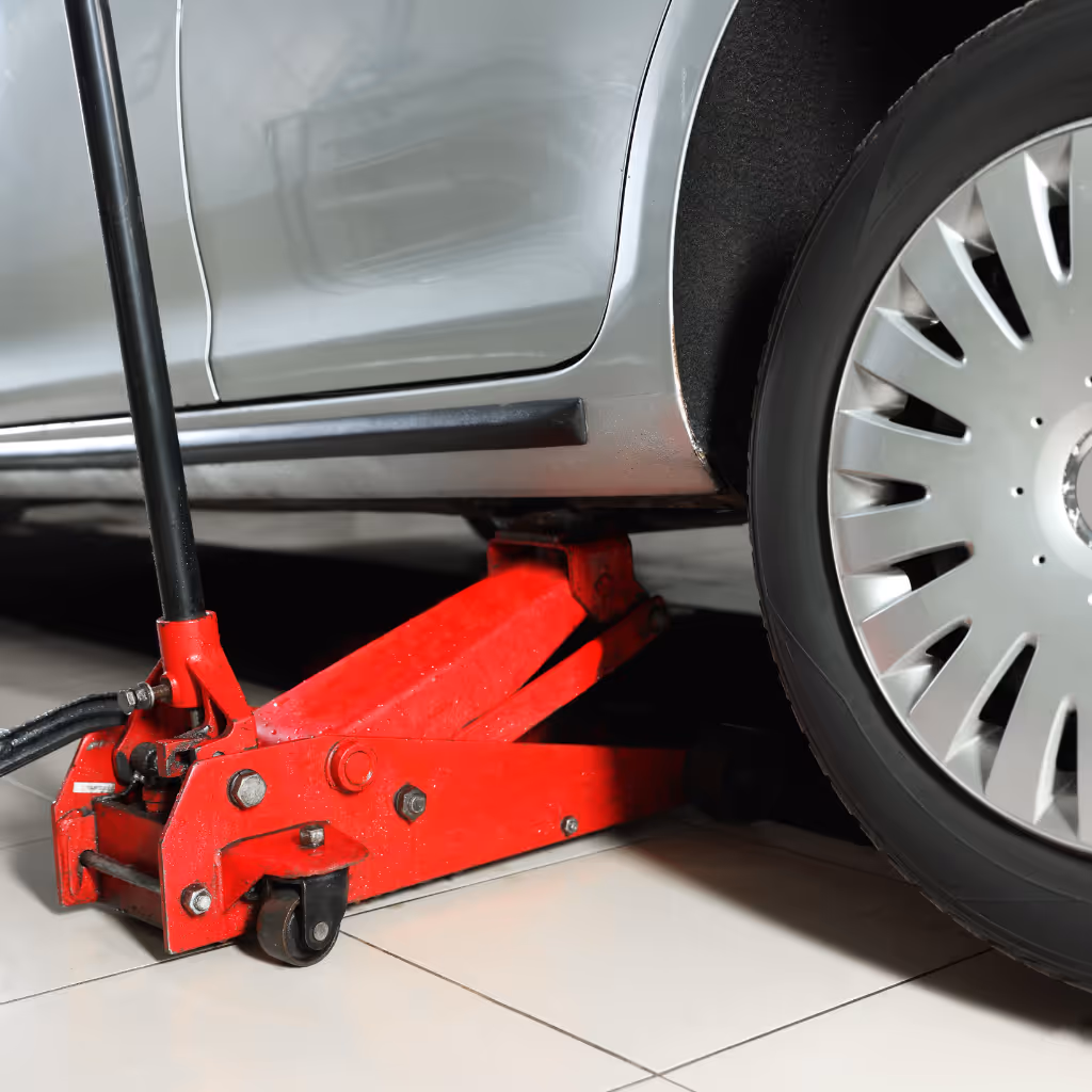 Using professional lifting equipment for a 185-point Premium Pre-Purchase Inspection in Reading. Graeme checks for structural rust, accident repairs, and fluid leaks under the vehicle.