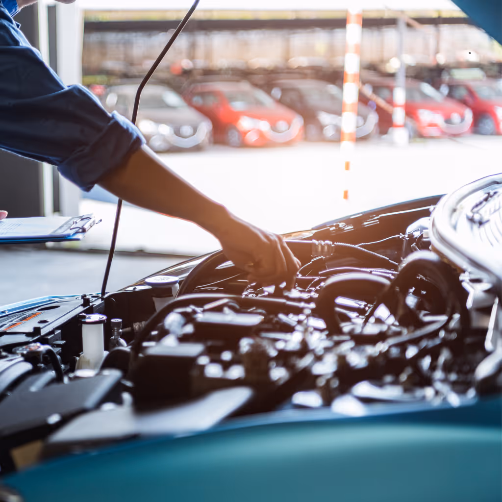 Graeme, head mechanic at Maxamy Mobile Autocare, performing a Basic 86-point mechanical assessment of oil levels and engine health at a dealership.