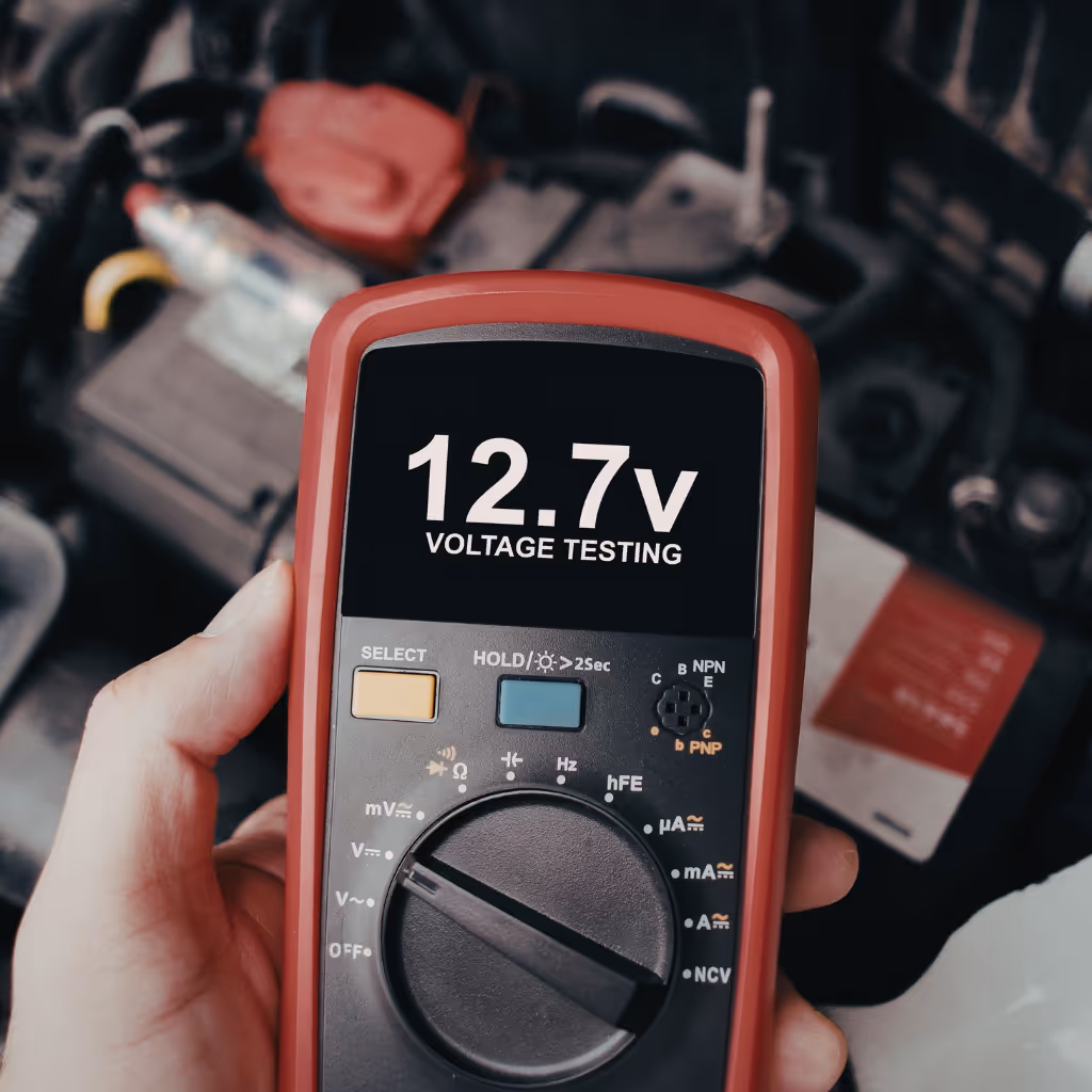 Graeme (35+ years in auto trade) performing a precise voltage test on the charging system during a pre-purchase inspection in Egham. We verify the alternator and battery condition on-site.