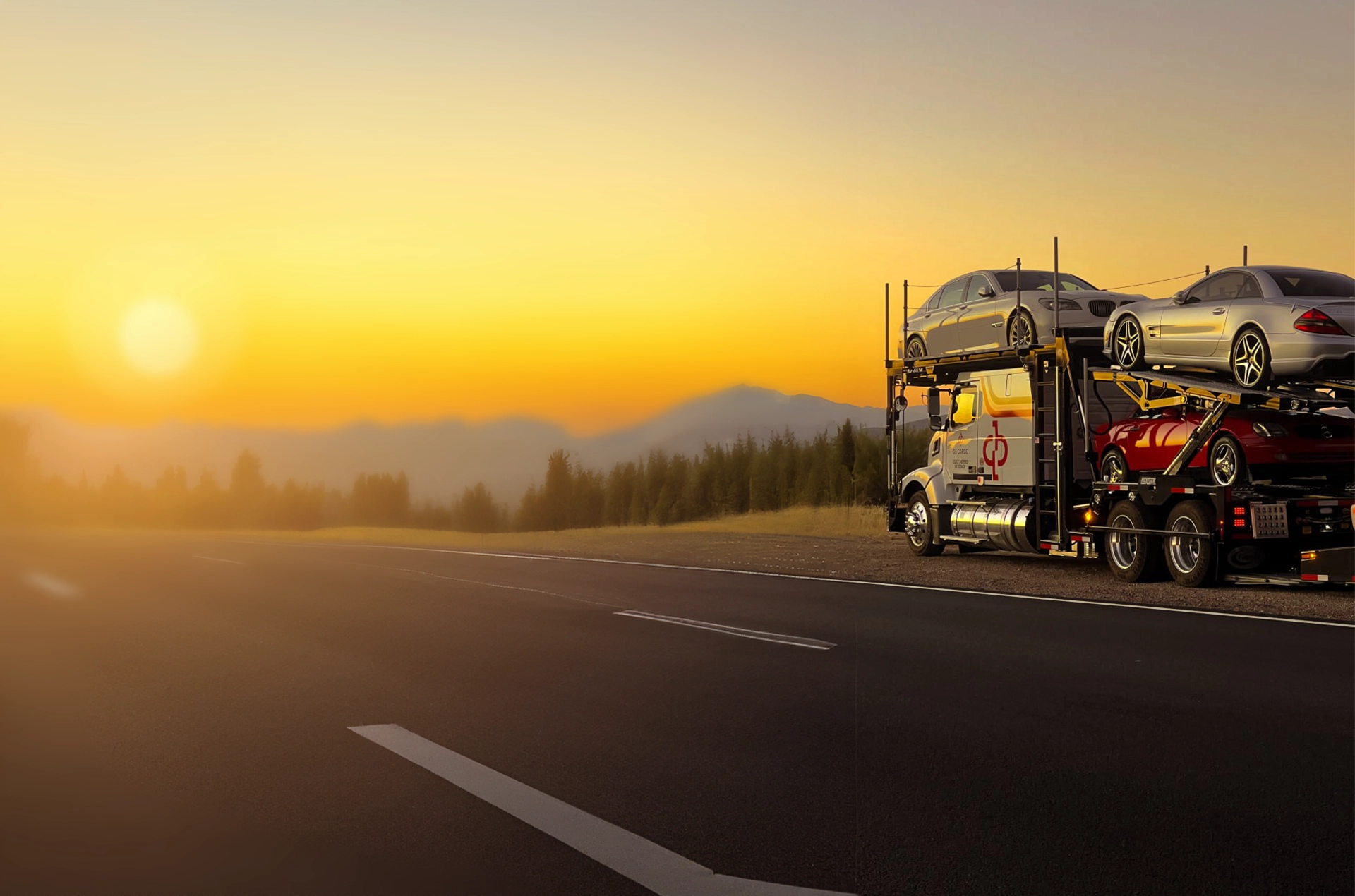 GB Cargo car hauling truck at a beautiful sunset.