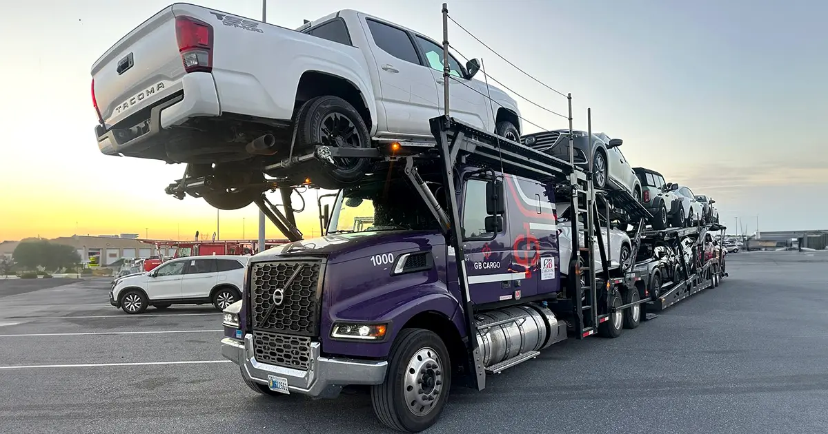GB Cargo car hauling truck loaded with cars in a parking lot