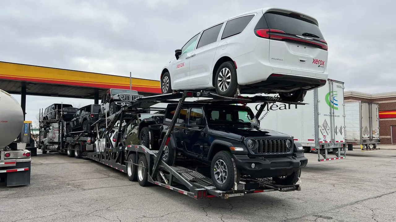 A loaded car hauling truck at a truck stop
