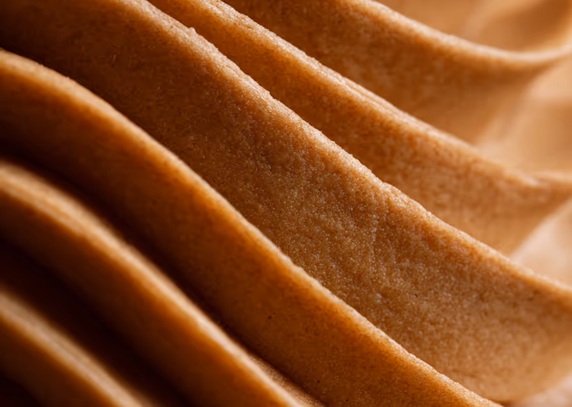 Close-up of folded brown fabric or paper with a textured surface.