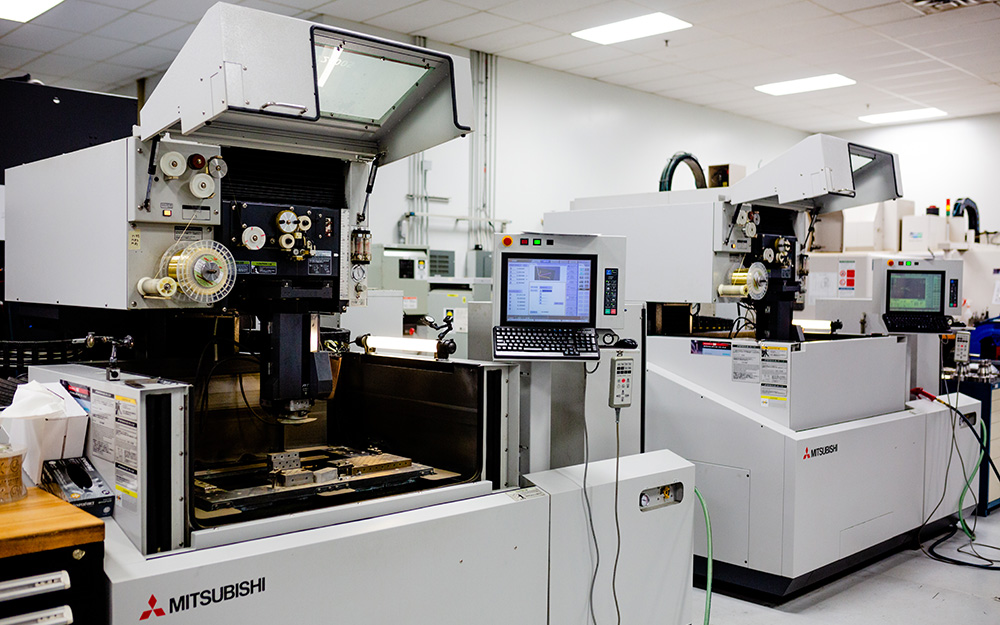 Precision manufacturing floor at JGA Space & Defense in Huntersville, featuring advanced Mitsubishi Wire EDM capabilities for tight-tolerance defense hardware.