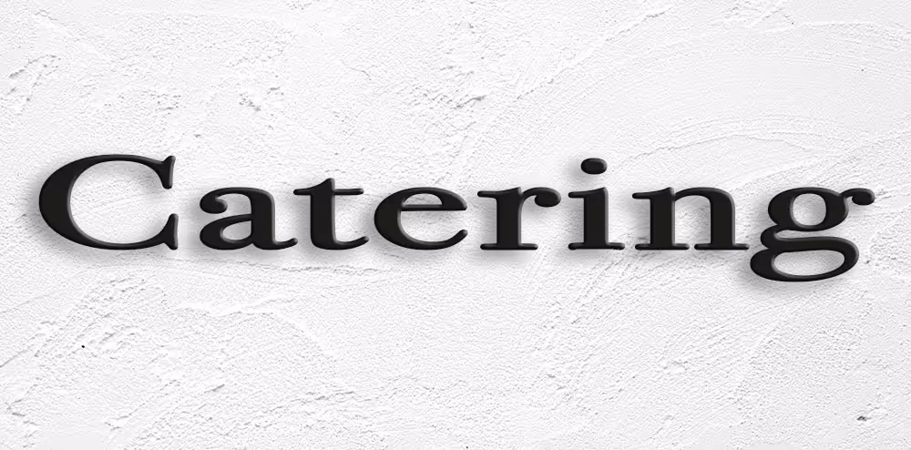 Black text reading 'Catering' on a white textured wall.