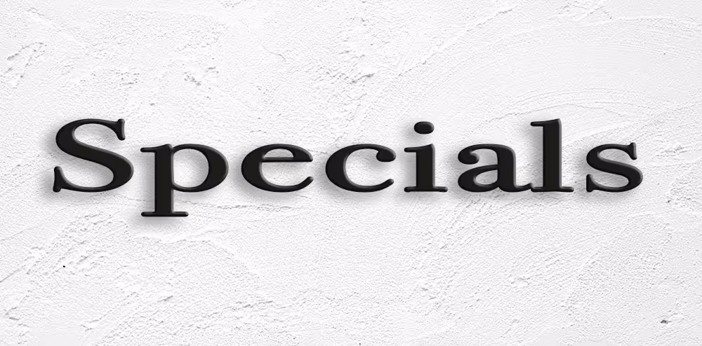 Black 3D text spelling 'Specials' on a textured white wall background.