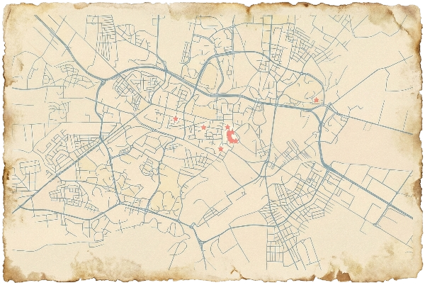 Vintage-style map with faded edges showing a city layout with blue roads and several red marked locations.
