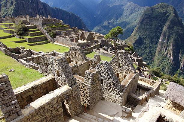 Machu Picchu at sunrise with mist over the Andes