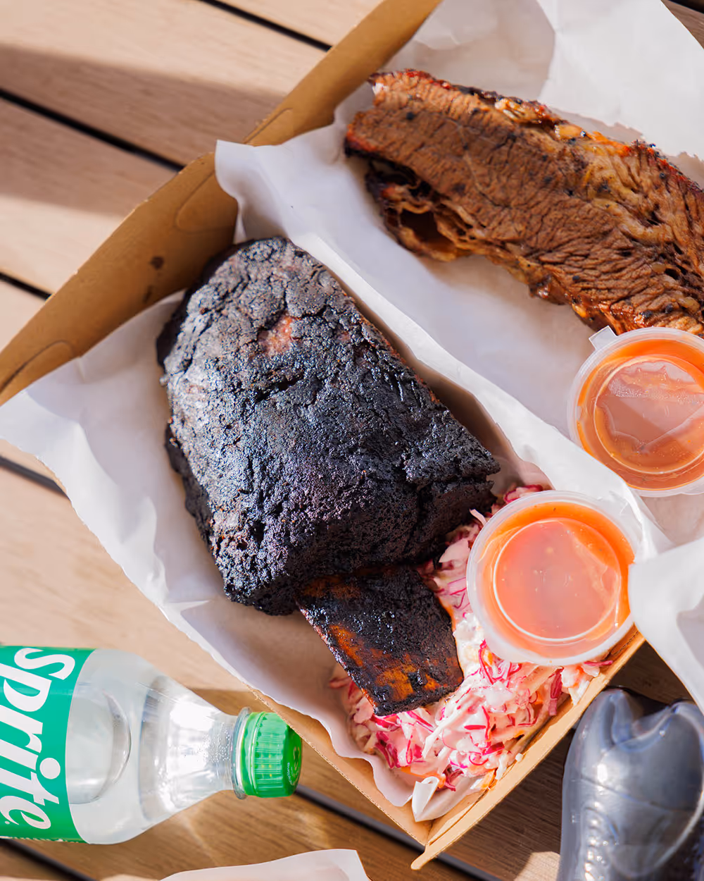 Assorted sausages cooking on a barbecue grill.