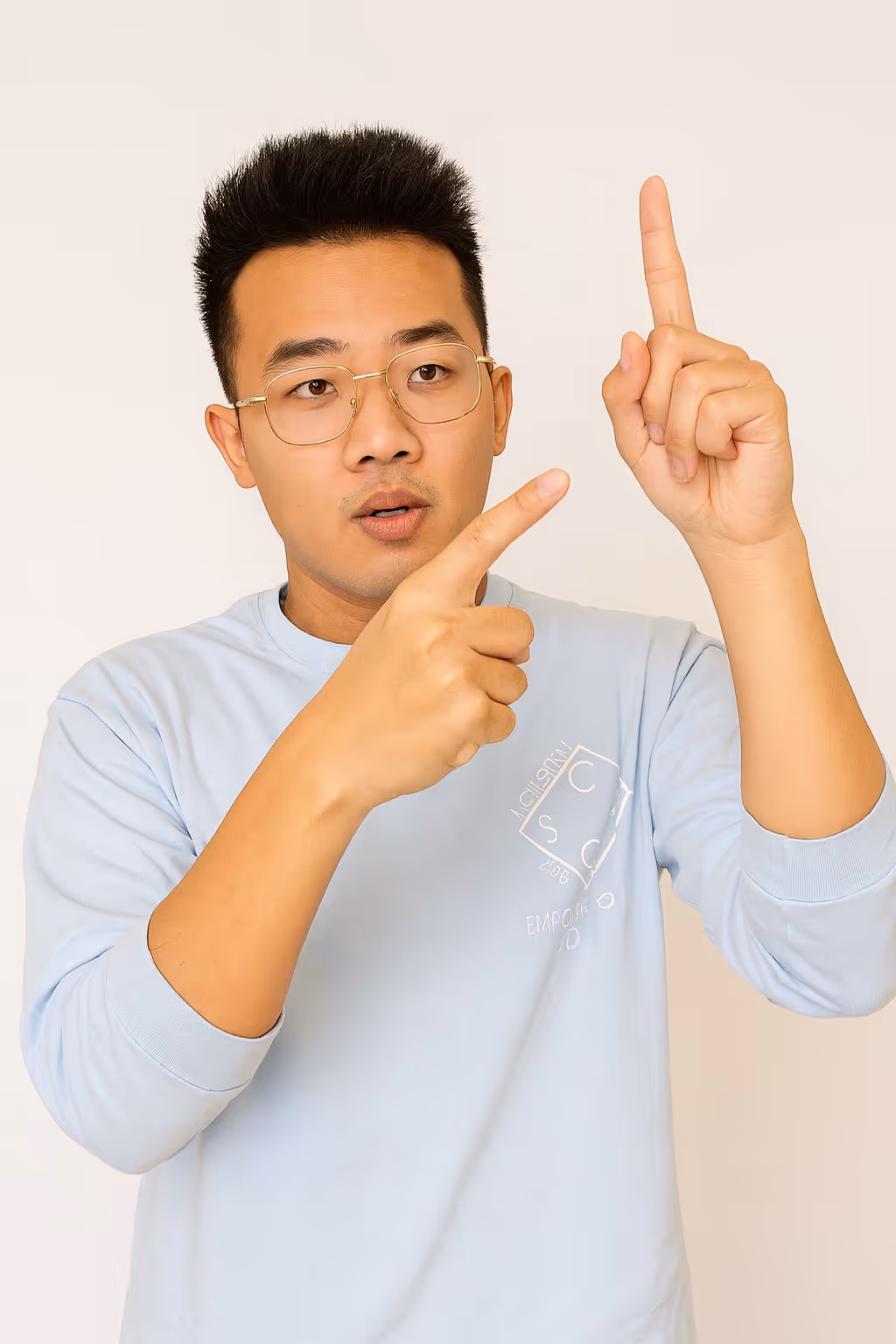 Asian man wearing glasses signing the word goal