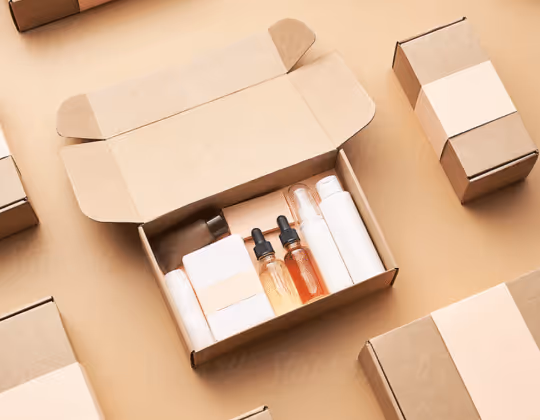 Open cardboard box containing various cosmetic bottles and containers with several closed cardboard boxes around it