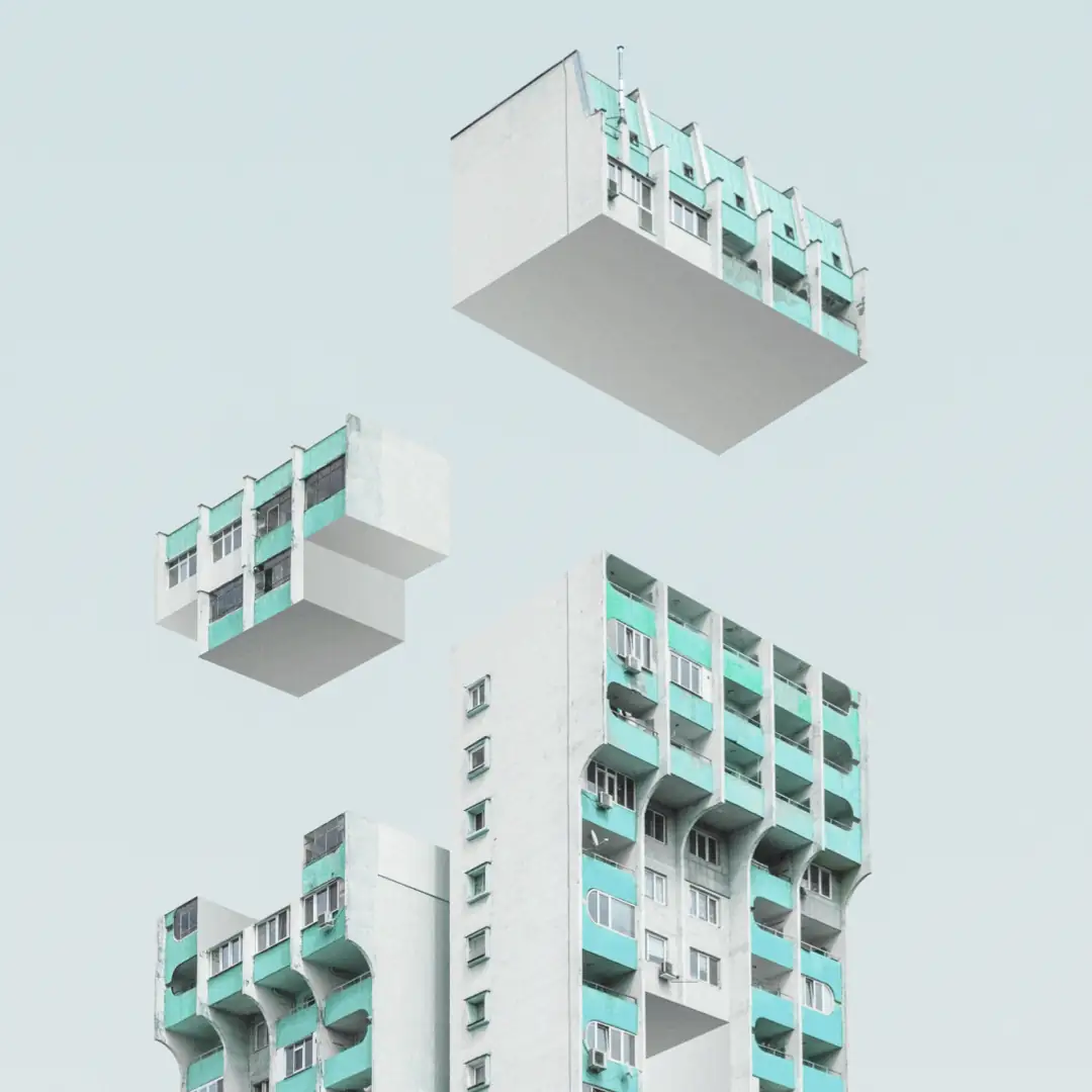 A fragmented high-rise building with sections floating separately against a pale sky