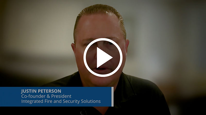 Man with short hair speaking in video with title: Justin Peterson, Co-founder & President.