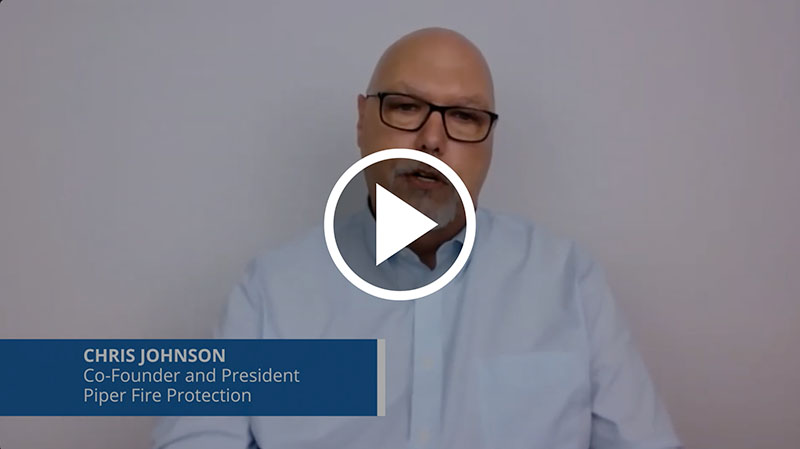 Man with glasses speaking in a video, titled Chris Johnson, Co-Founder and President of Piper Fire Protection.