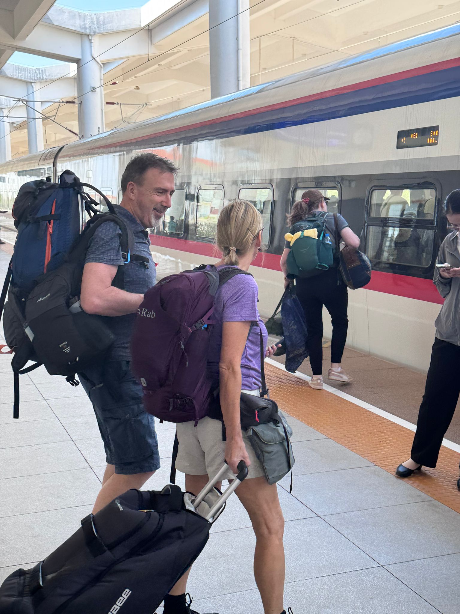 retirees board a train in Laos for their gap year