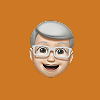 Smiling elderly man emoji with gray hair, glasses, and a mustache on a red background.