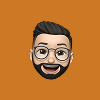Cartoon avatar of a man with glasses, beard, and a smile on an orange background.