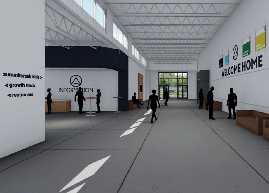 Spacious, modern hallway with high ceiling, large windows, information desk, directional signs, and silhouettes of people walking or standing.
