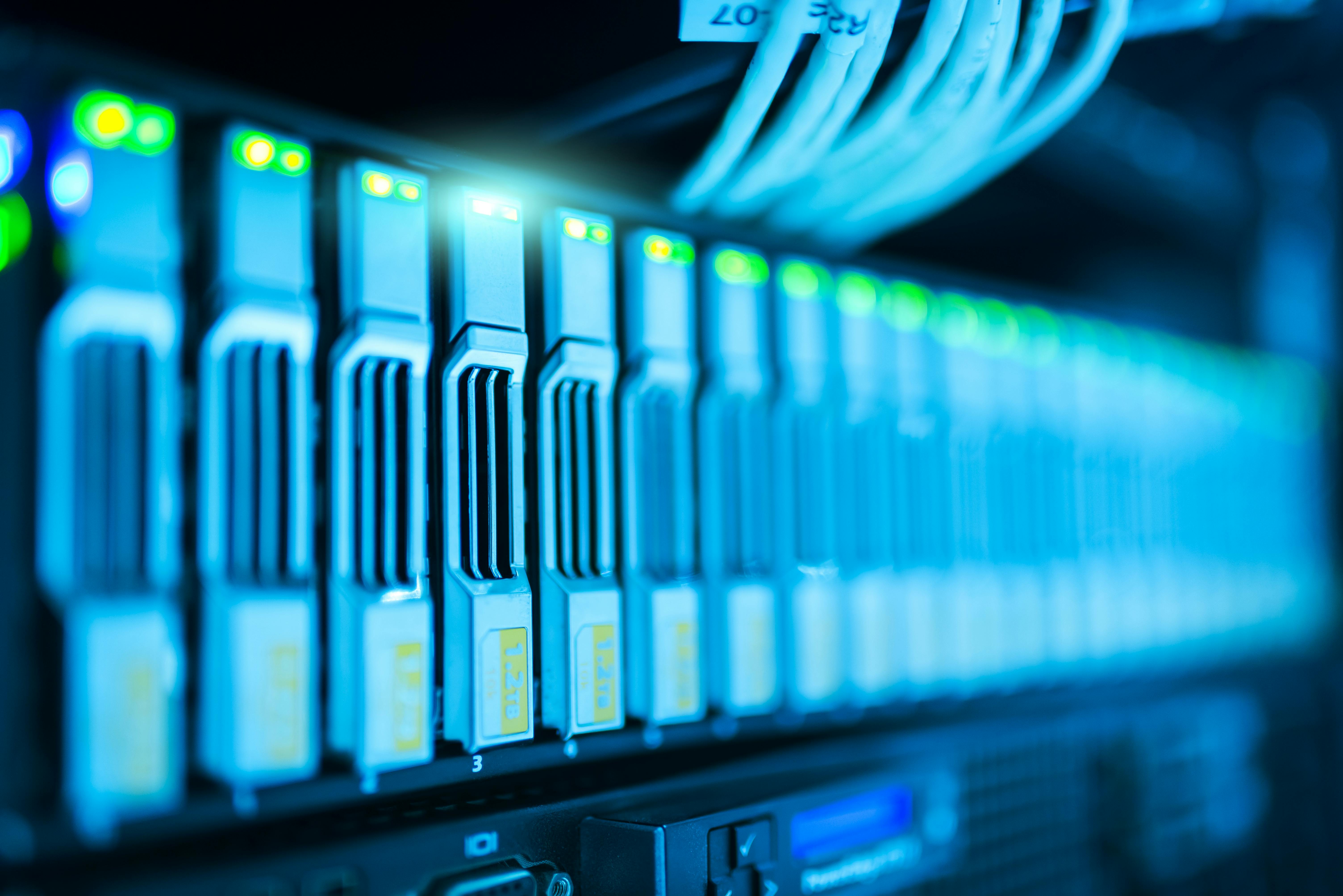 Illuminated rack-mounted data storage servers and network cables.