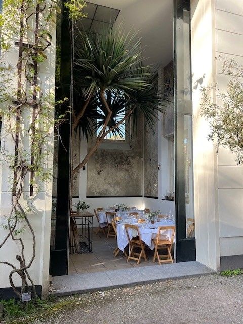 View through to the laid dinner tables in the orangery of the Hortus Botanicus