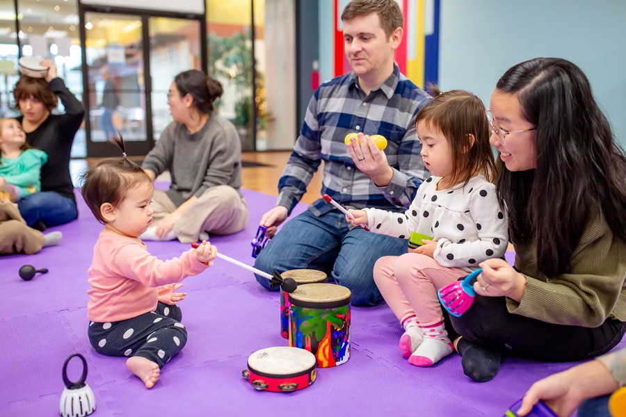 Children and caregivers making music together