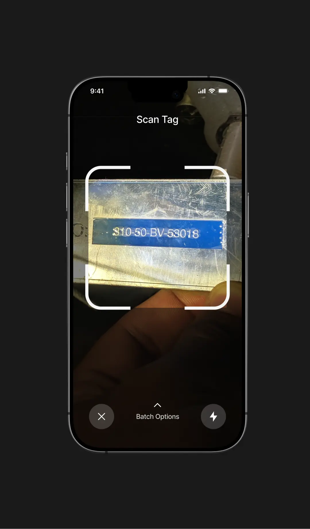 Smartphone screen showing a scanning app focused on a metal tag with the code 310-50-BV-53018.