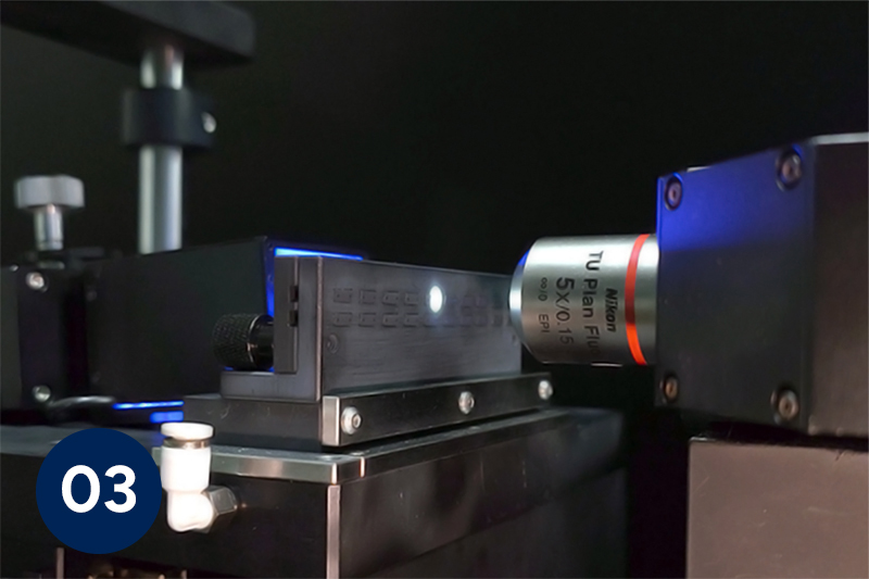 Microscope lens focused on a MT MMC Ferrules for automated inspection in a lab setup.