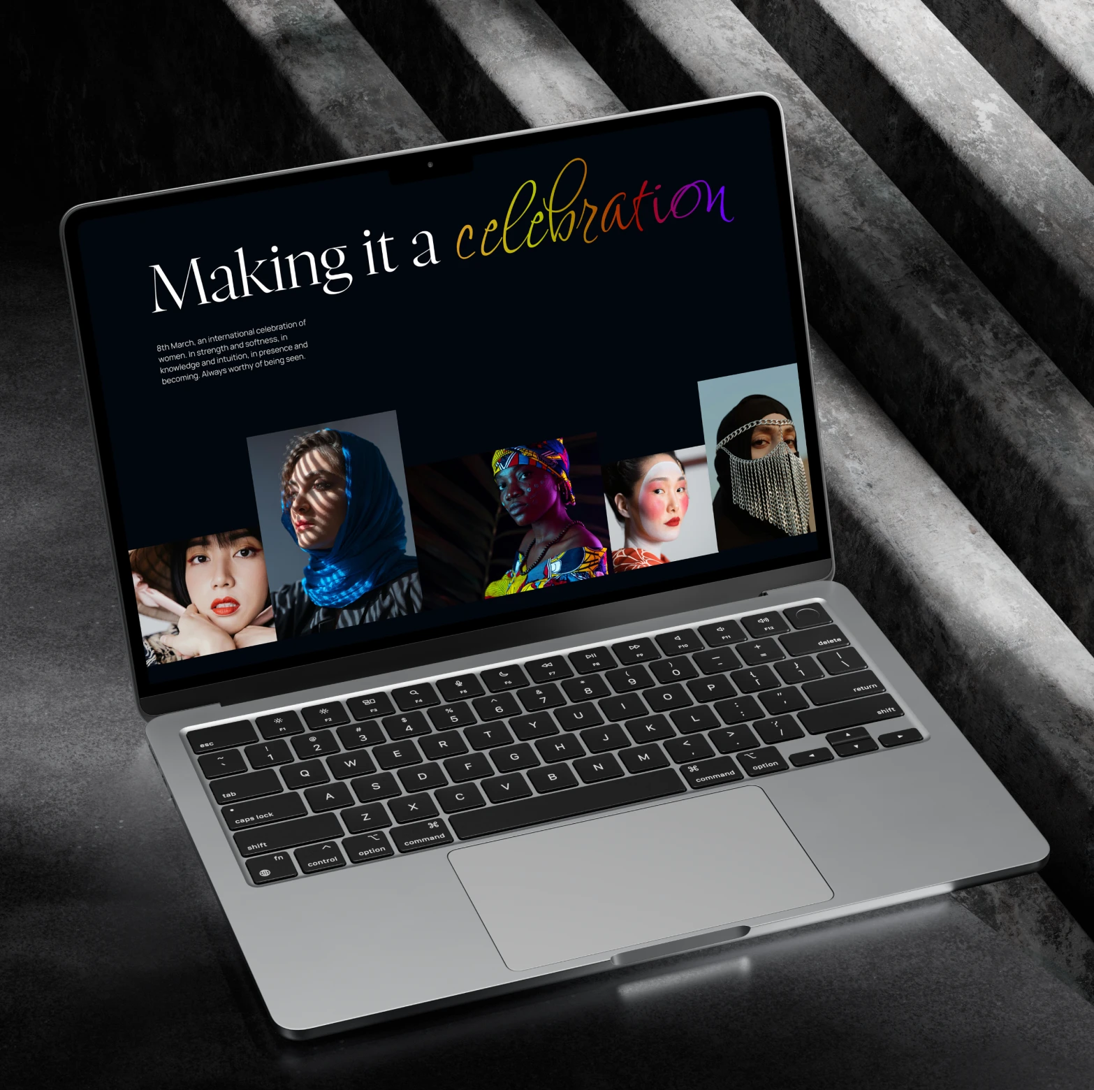 Laptop displaying a webpage titled 'Making it a celebration' with portraits of diverse women below the text.