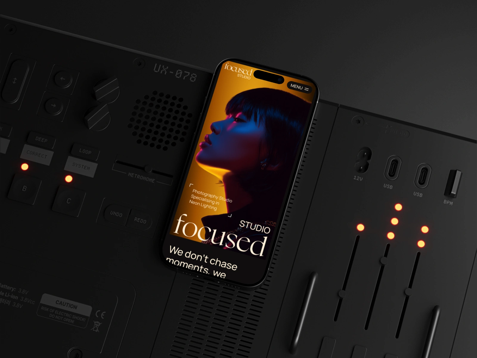 Smartphone with neon-lit portrait on music mixer or audio equipment surface with glowing controls from the Focused Webflow Template created by Guilty as Foxx