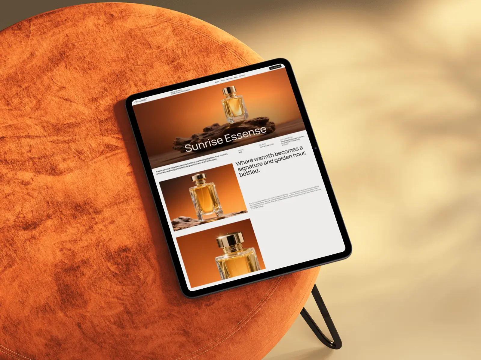 Tablet showing website for Sunrise Essense perfume placed on round orange suede stool from the Stillness Webflow Template created by Guilty as Foxx