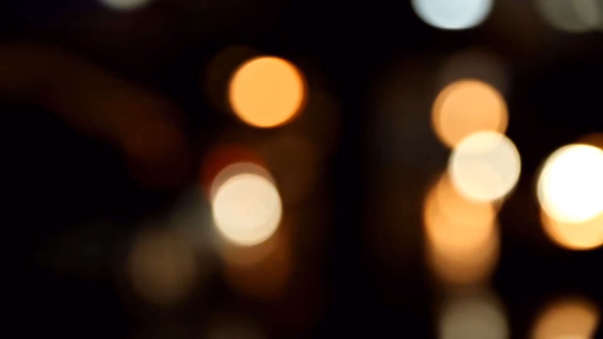 A blurry photo of a city street at night.